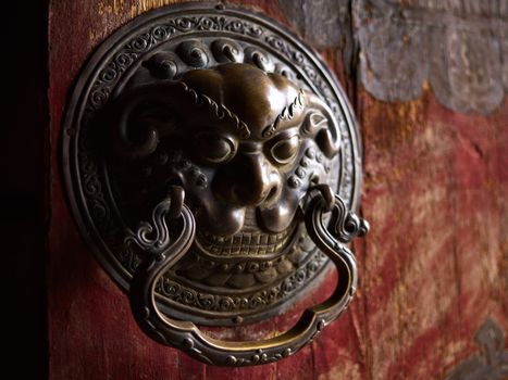 Ancient door handle on wooden door