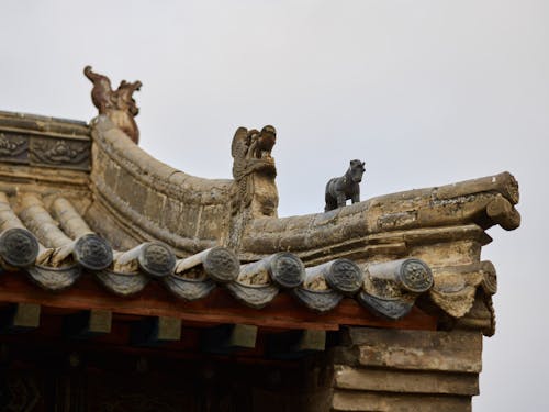 Details of old oriental temple against cloudy sky