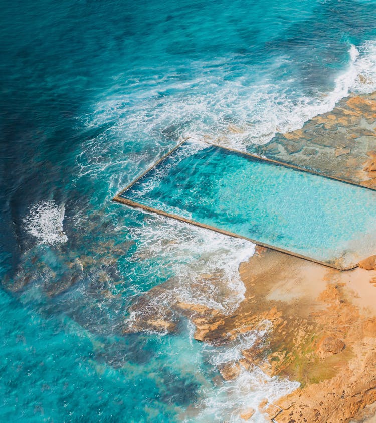 Aerial View Of Crashing Waves On The Rocky Shore