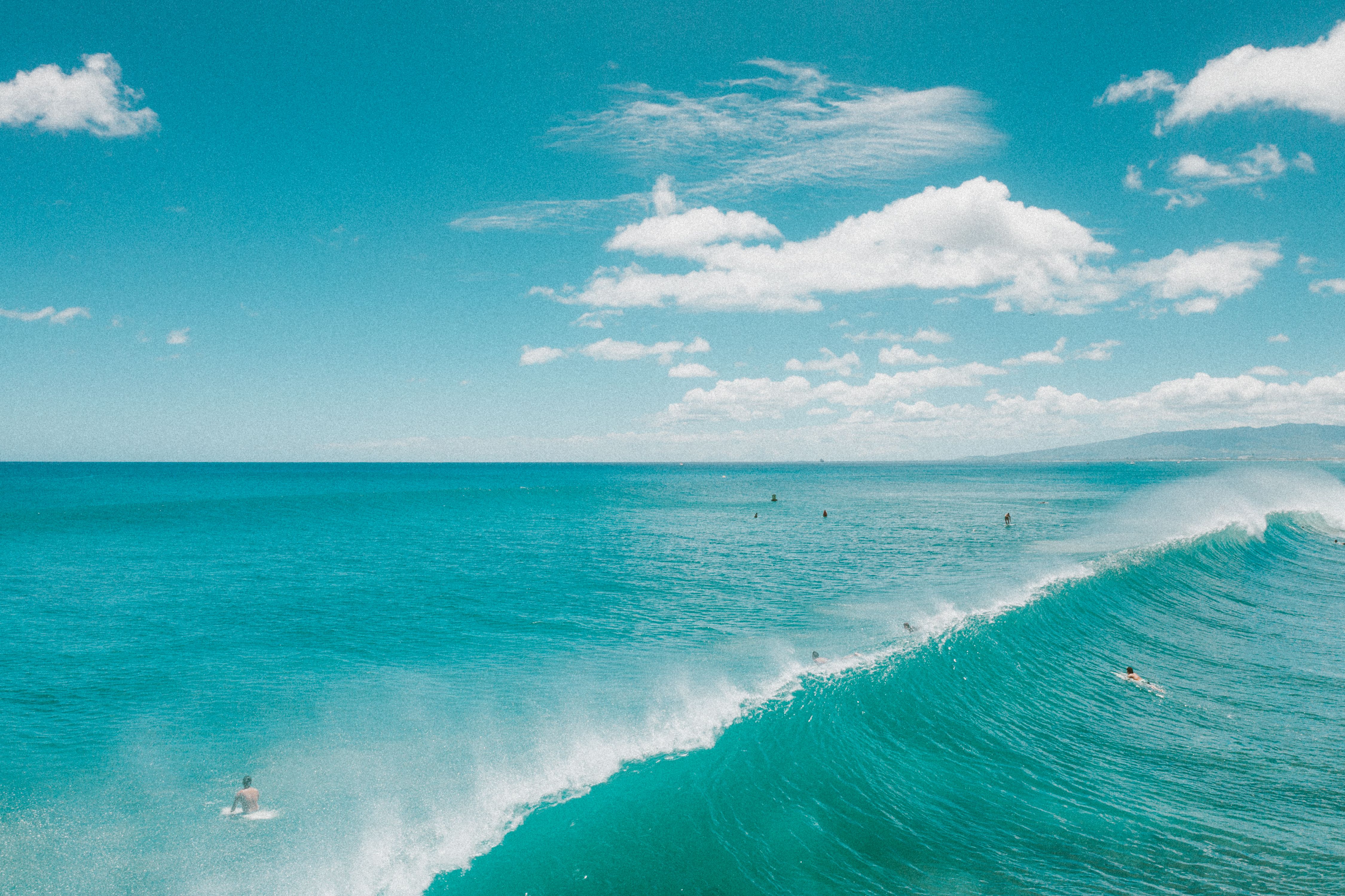Beginner surfers learning to ride waves in Santa Catarina beach