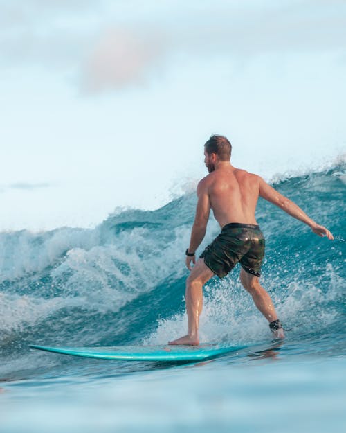 Man in Black Shorts Jumping on Water