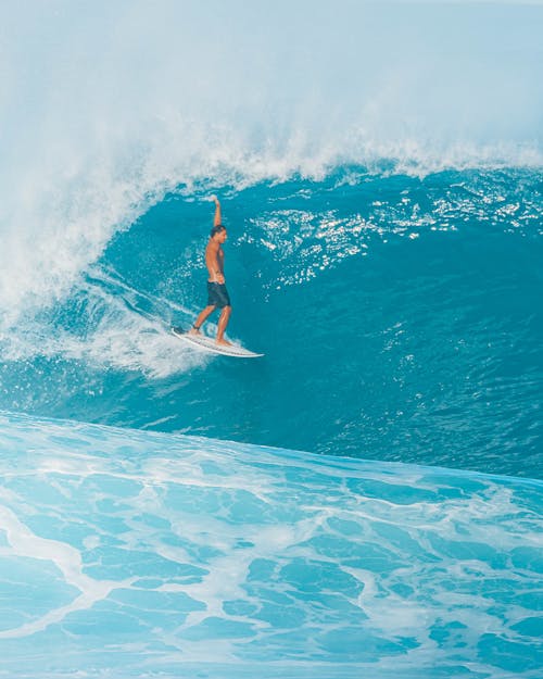 Man Surfing on Blue Sea