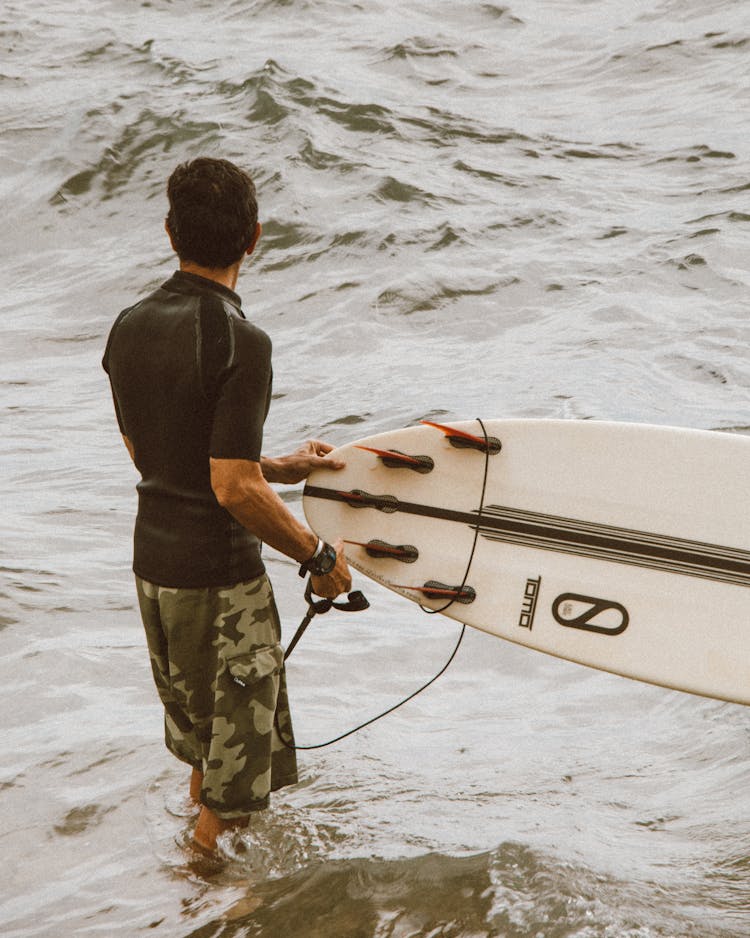 Man Holding A Surfboard