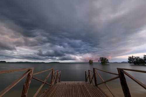 Free stock photo of green, pier, rain clouds