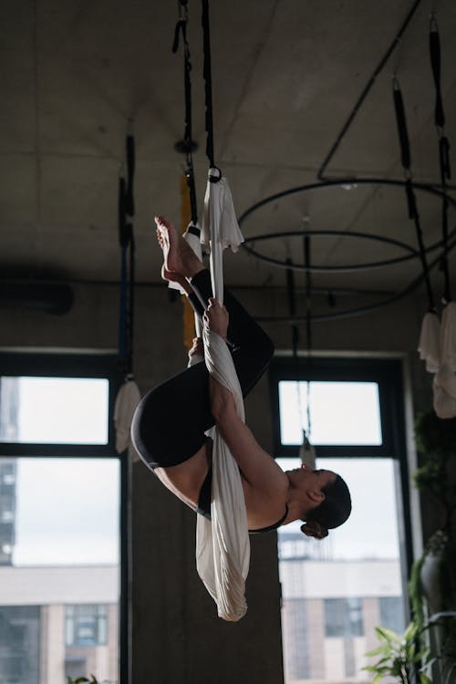 Man in White Tank Top Holding White Rope