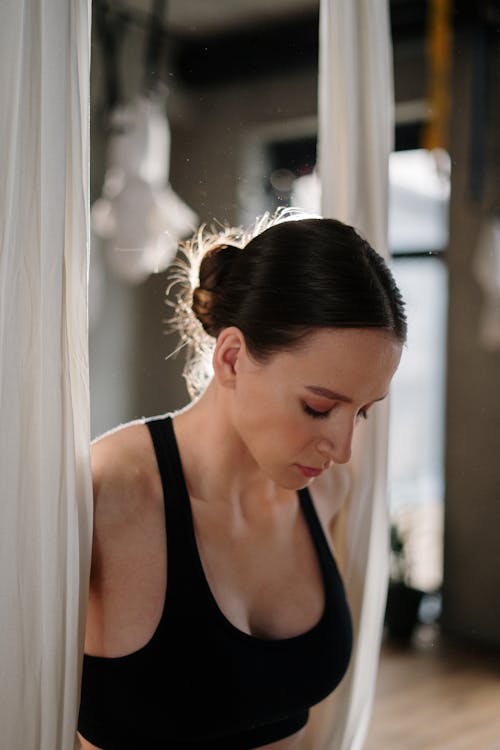 Woman in Black Tank Top Looking Down