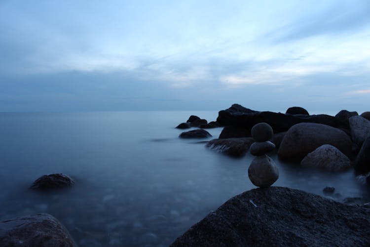 Stones Stacked On Sea Shore