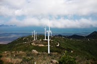 Windmills on green hill in countryside