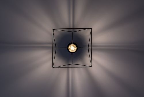 Free A minimalist ceiling light creates stunning geometric shadows, captured from a low angle. Stock Photo
