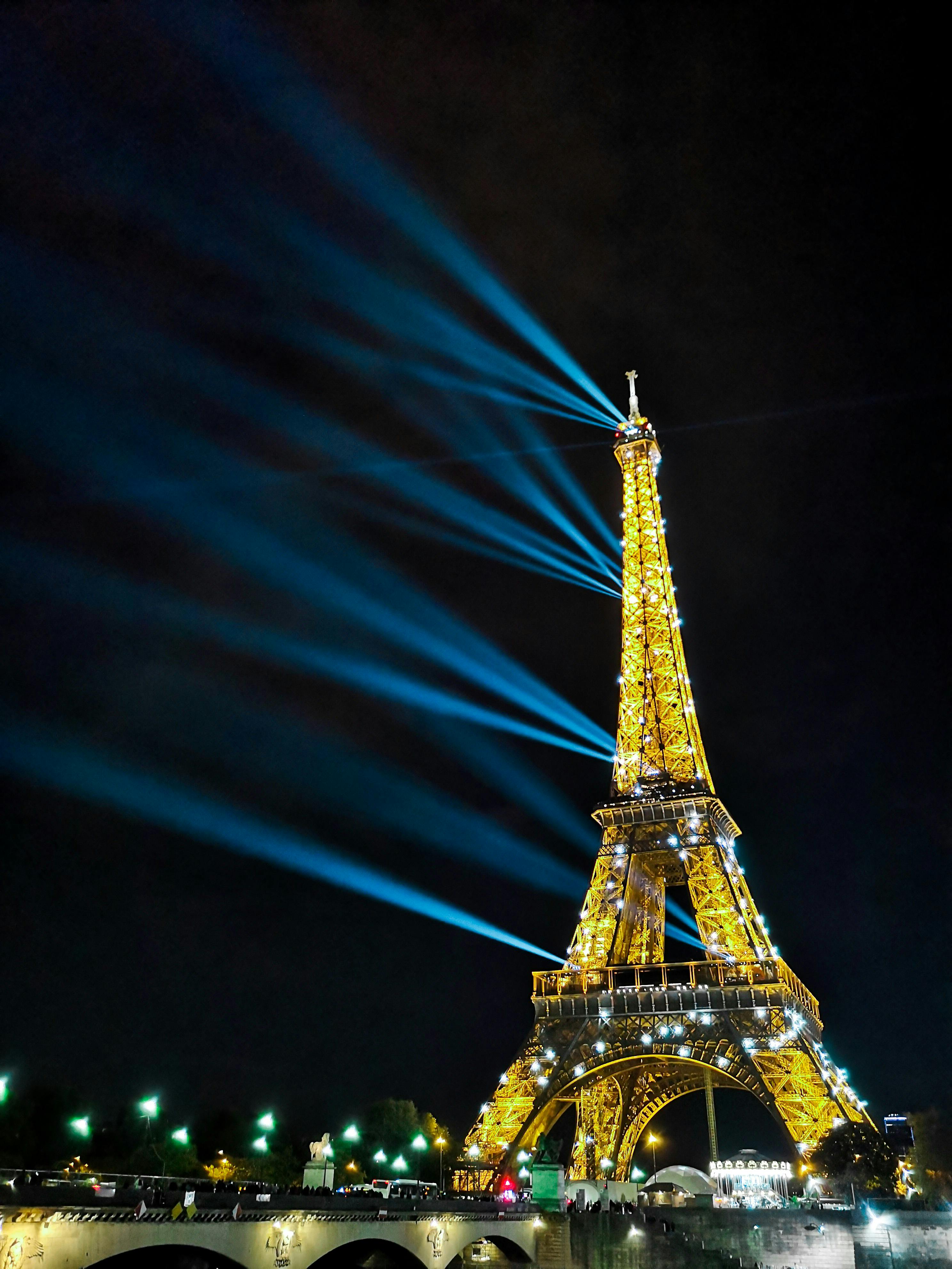 Illuminated Eiffel Tower with sparkling lights at night · Free Stock Photo