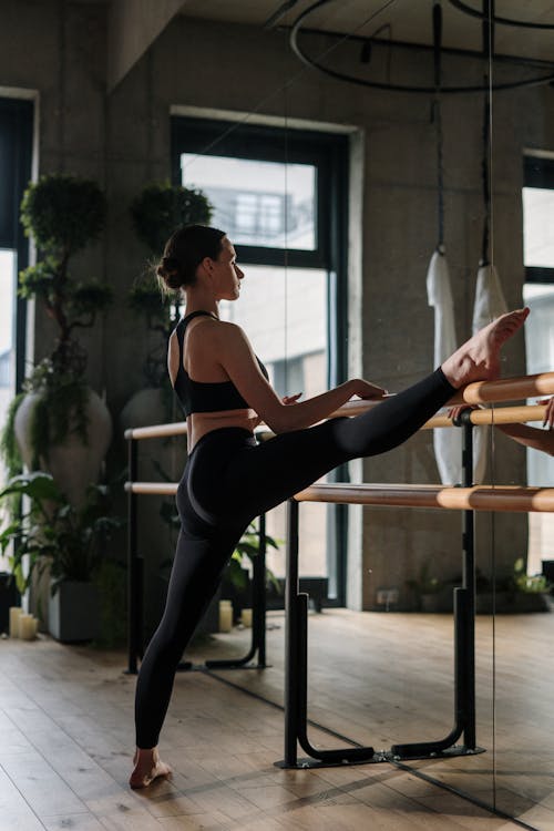 Woman in Black Sports Bra and Black Leggings Doing Yoga
