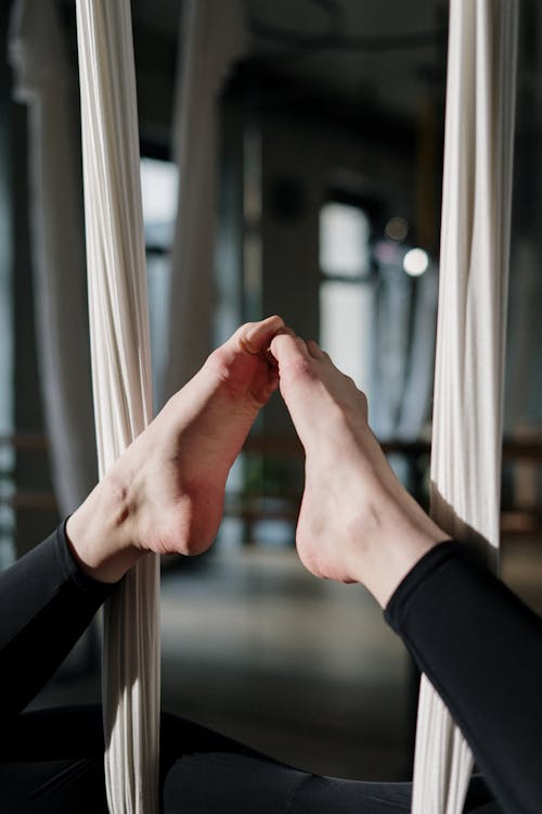 Person in Black Long Sleeve Shirt Holding Glass Window