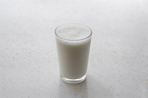Free A Glass of Milk on a White Surface Stock Photo