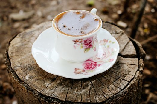 Ceramic cup with black frothy coffee