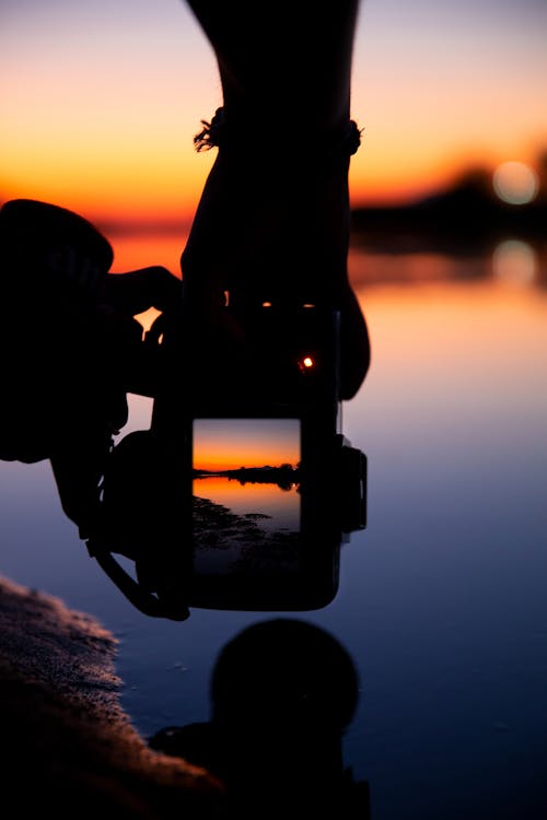 Silhouette of Man Holding a Camera