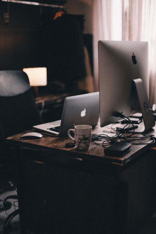 Silver Macbook on Brown Wooden Table · Free Stock Photo