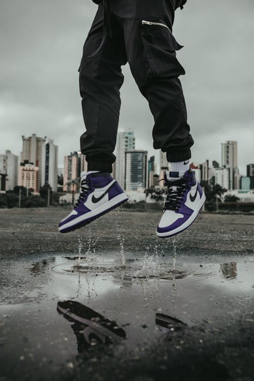 Free Crop cool guy jumping above ground Stock Photo