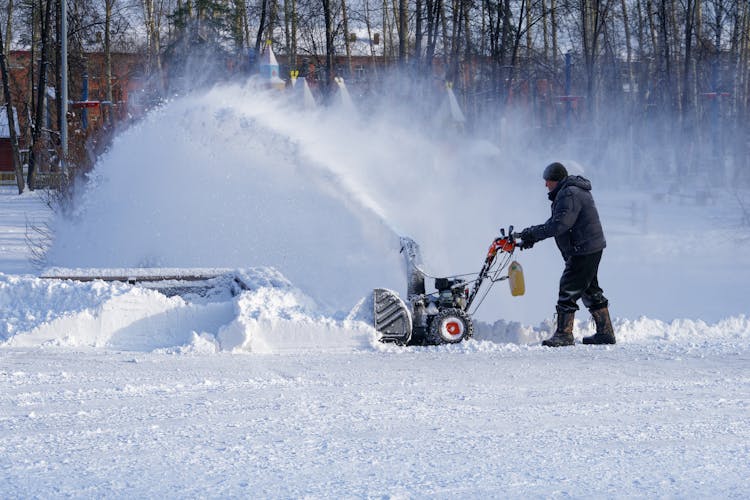 Man Removing Snow With Snow Blower