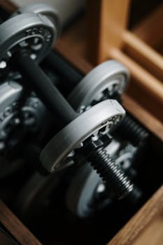 Detailed shot of dumbbells in a gym, emphasizing fitness equipment.