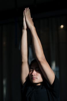 A man practicing yoga indoors, focusing on mindfulness and wellness.
