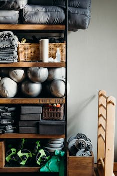 Neatly arranged gym and yoga equipment on wooden shelves, perfect for fitness studios.