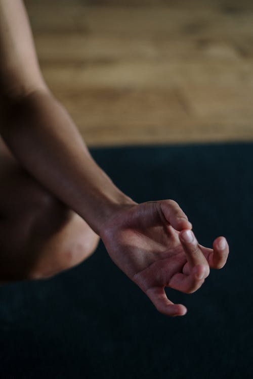 Person Holding Feet With Pink Nail Polish