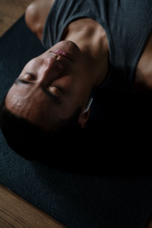 Free Shirtless man meditating indoors with headphones and eyes closed, embracing relaxation and wellness. Stock Photo