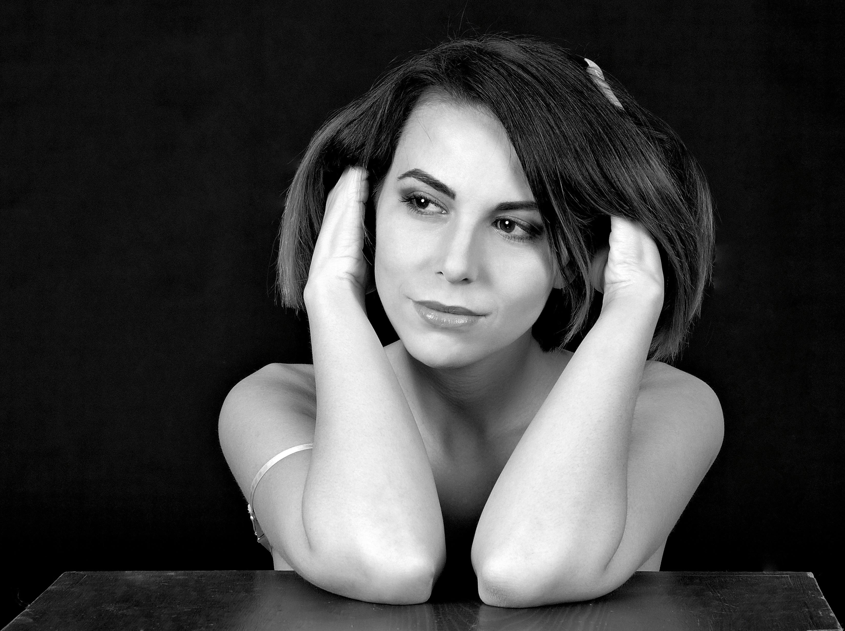 Woman in Tank Top Blowing Dandelion in Grayscale Photography · Free Stock Photo