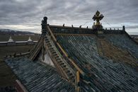 From above of ancient Erdene Zuu Buddhist monastery with tiled roof and decorative roof elements under overcast sky in evening