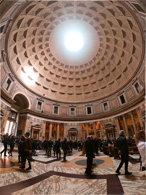 Free People walking under dome in museum Stock Photo