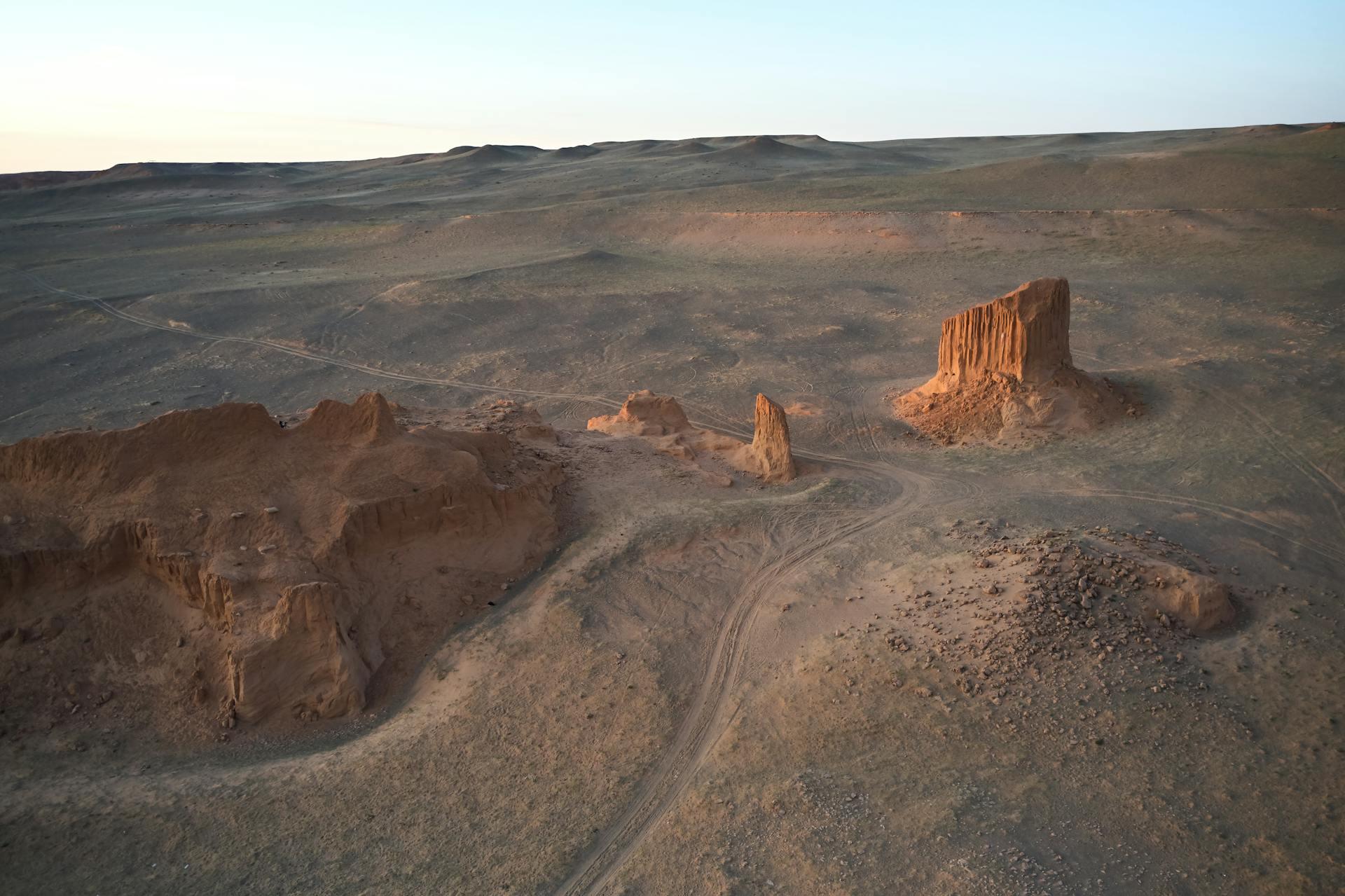 Amazing drone view of rough terrain of Gobi desert with stand alone Flaming Cliffs on quiet evening