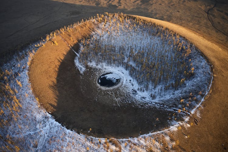 Black Puddle In Round Sand Cavity In Evening