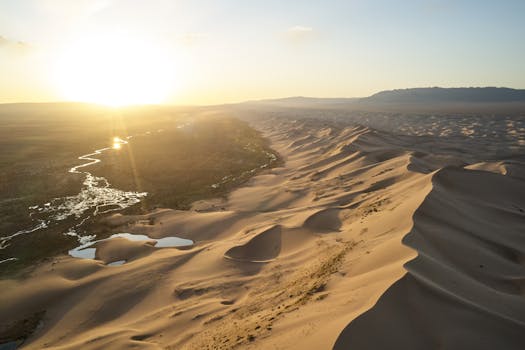 Breathtaking aerial view of the Gobi Desert dunes in Mongolia during sunset, with serene landscape.