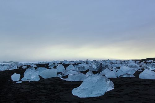 Free Scenic view of glacial ice blocks on a black sand beach at dusk, Iceland. Stock Photo