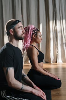 Adults practicing yoga meditation in a serene studio setting, promoting wellness and relaxation.