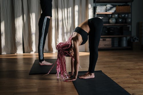 Woman in Black Leggings and Pink Scarf Doing Yoga