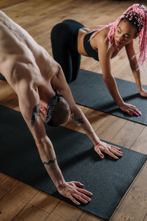 Woman in Black Sports Bra and Black Shorts Doing Yoga