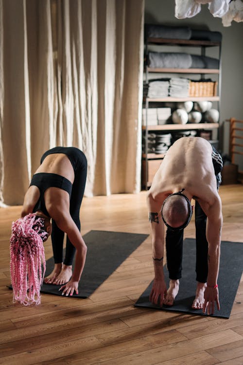 Woman in Black Sports Bra and Pink Skirt Doing Yoga Pose