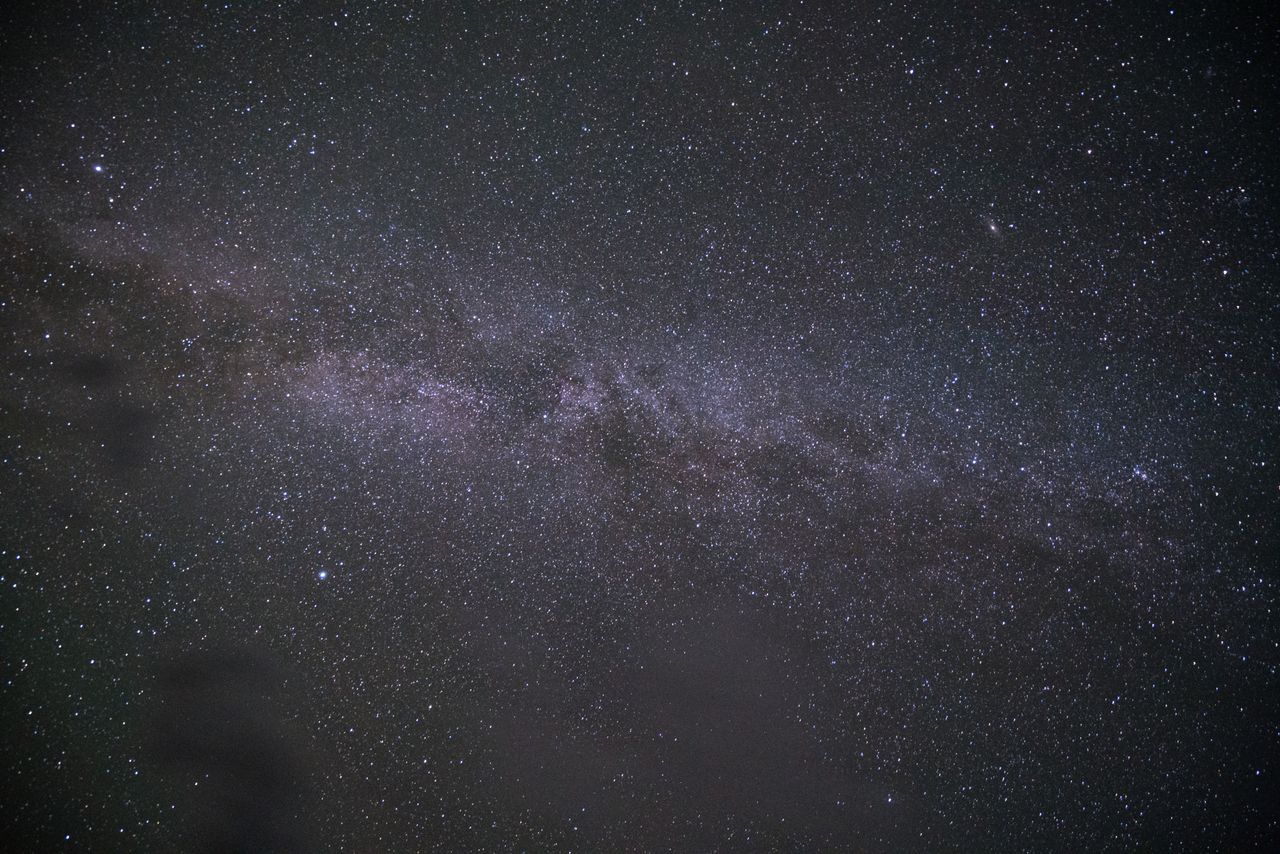 from below picturesque view of glowing pleiad of stars on night sky on