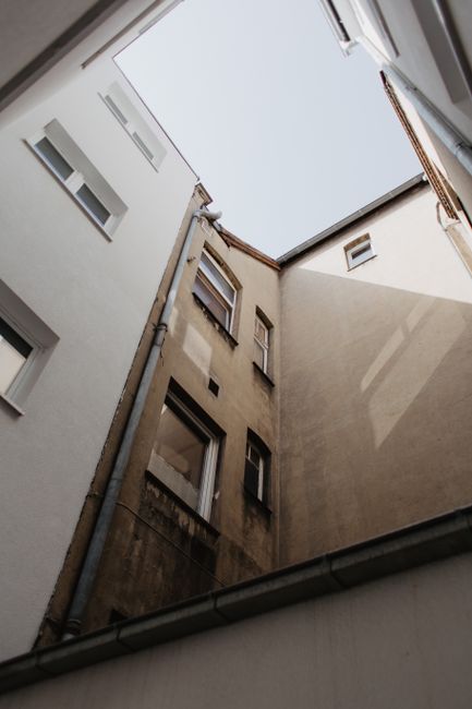 A unique perspective of urban building facades seen from a low angle, highlighting architectural details.