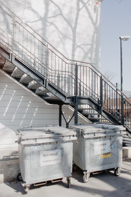 Waste Containers in the Alley Next to the Stairs