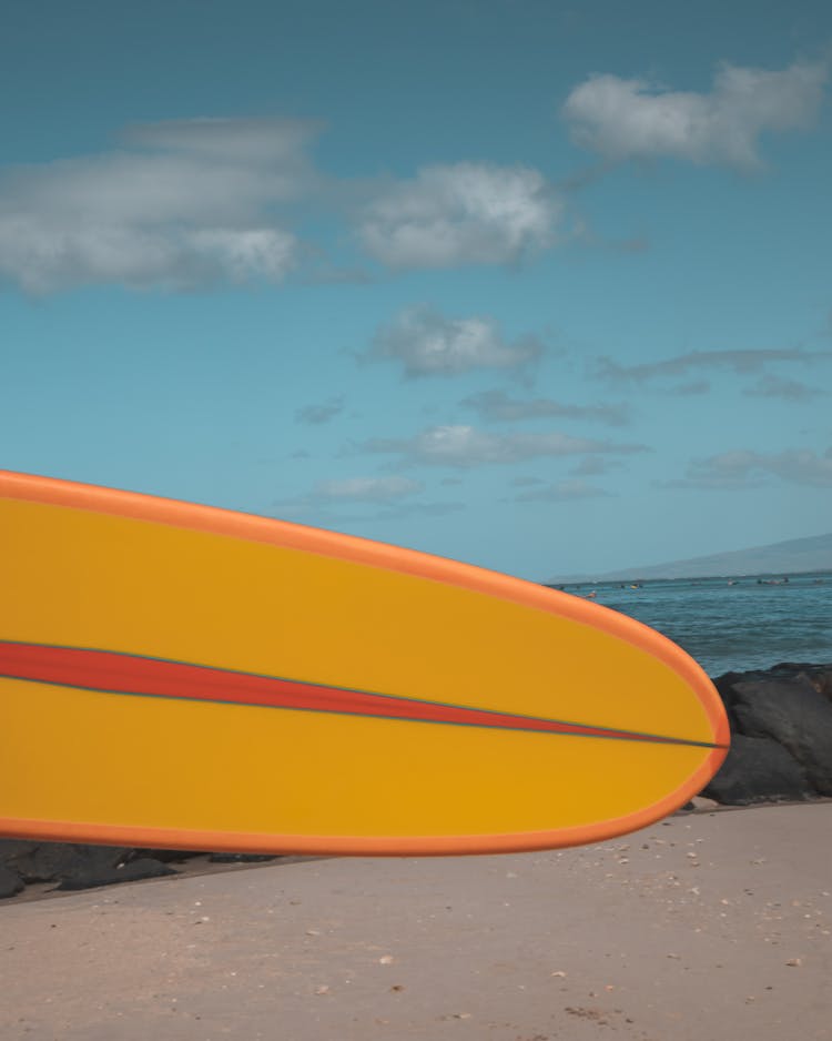 Orange Surfboard On Beach Shore