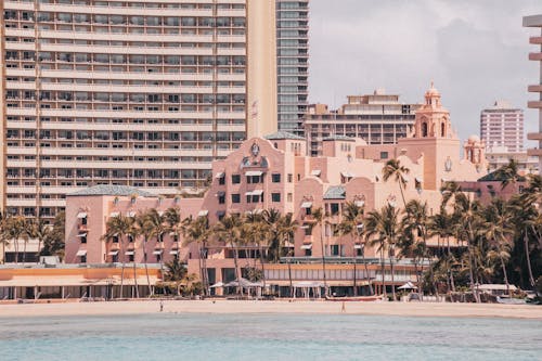 Pink Concrete Building Near Body of Water