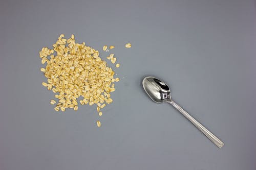 Scattered of Cereal Besides a Silver Teaspoon 