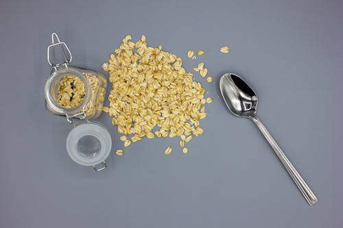 Free A Silver Teaspoon Besides A Jar of Cereal Stock Photo