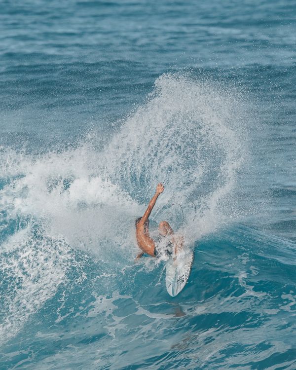 Man Riding Wave Man Riding a Wave on a Surfboard · Free Stock Photo