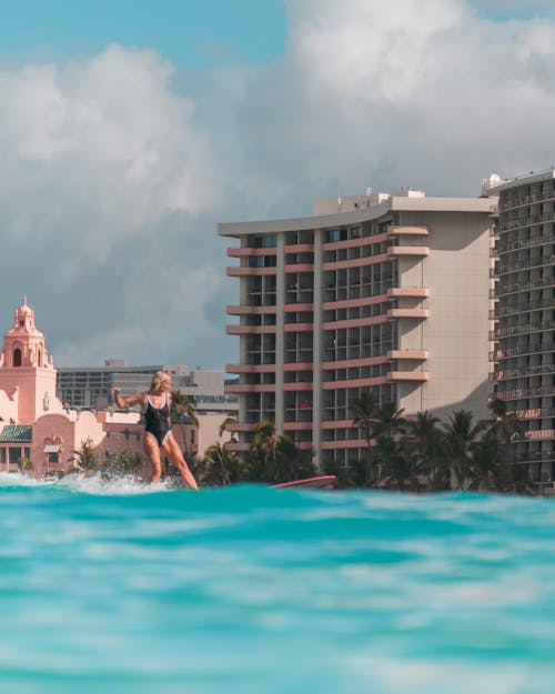 Woman Standing by a Swimming Pool at a Resort