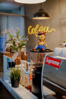 Various coffee equipments placed on table under light round lamps in modern cafe
