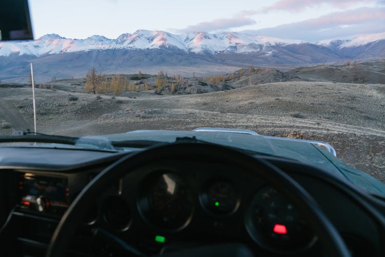 Mountains Against Blue Sky Seen From Inside Of Car