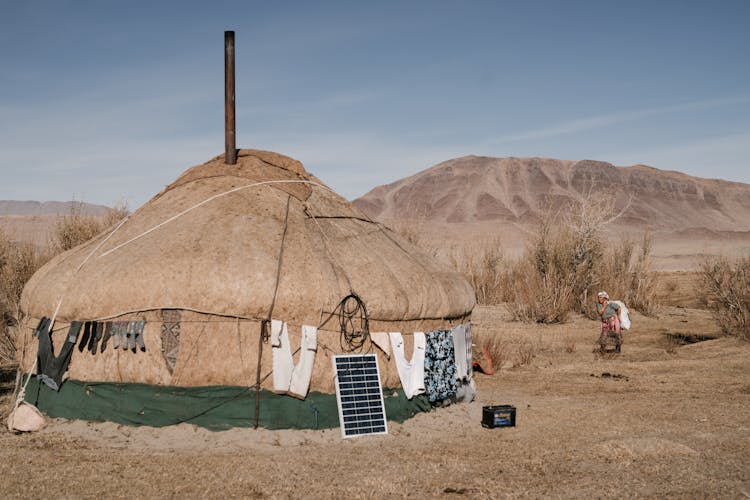 Woman Going In Yurt In Steppe